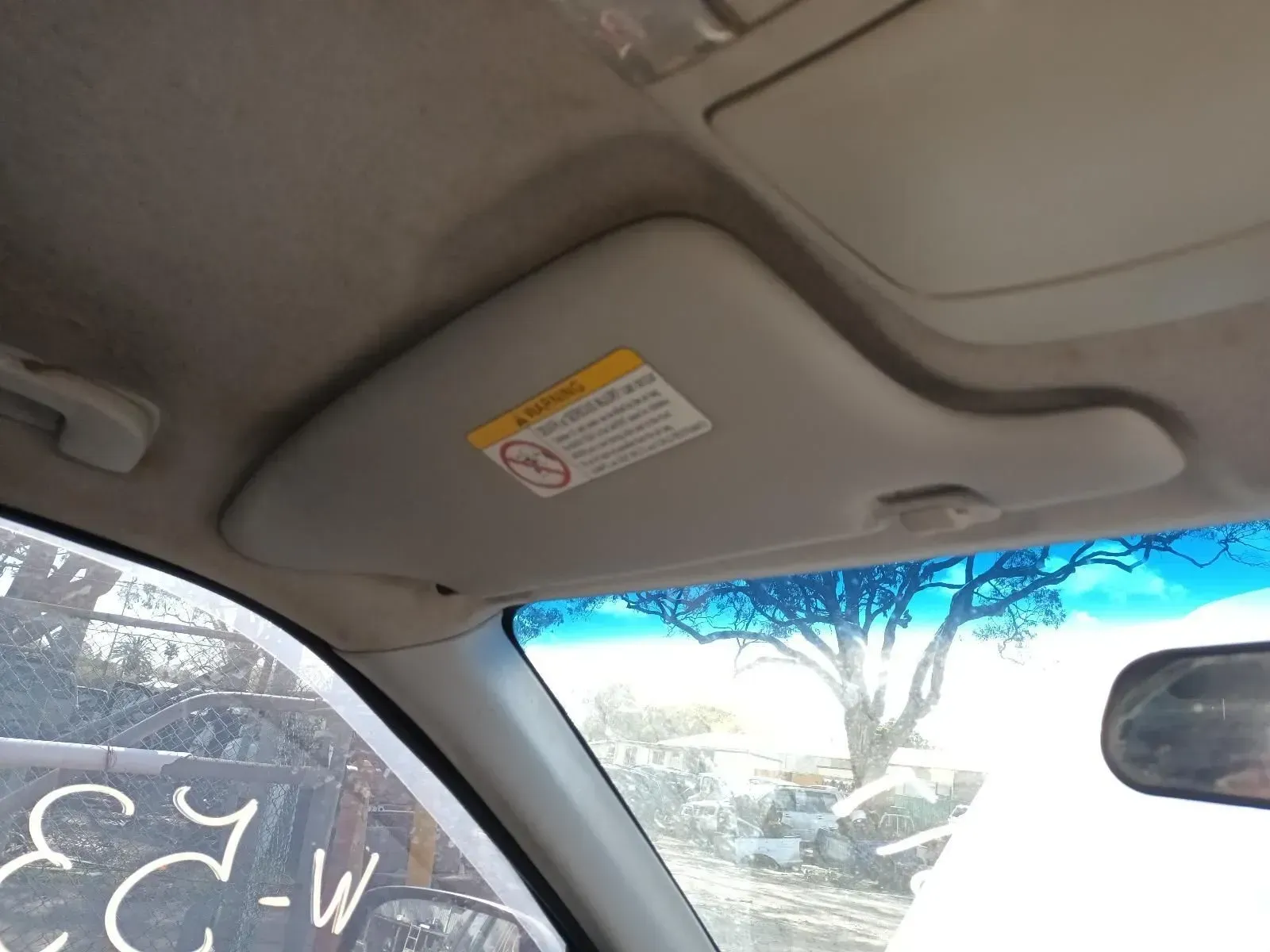 Interior View of Car, Sun Visor Extended, With Warning Label — South West 4WD Wreckers In Brisbane, QLD