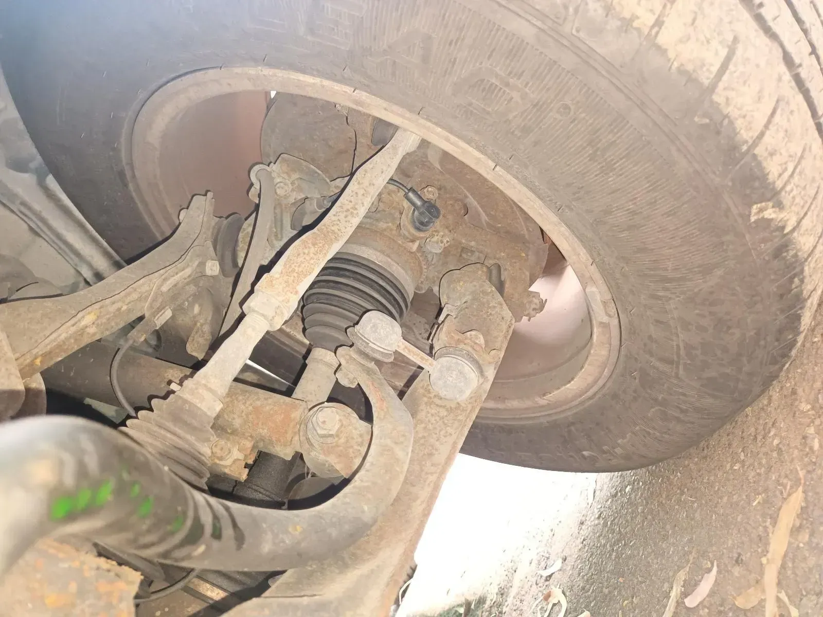 Rusty Car Suspension Components, Including a Wheel, Tyre, and Various Metal Parts — South West 4WD Wreckers In Brisbane, QLD