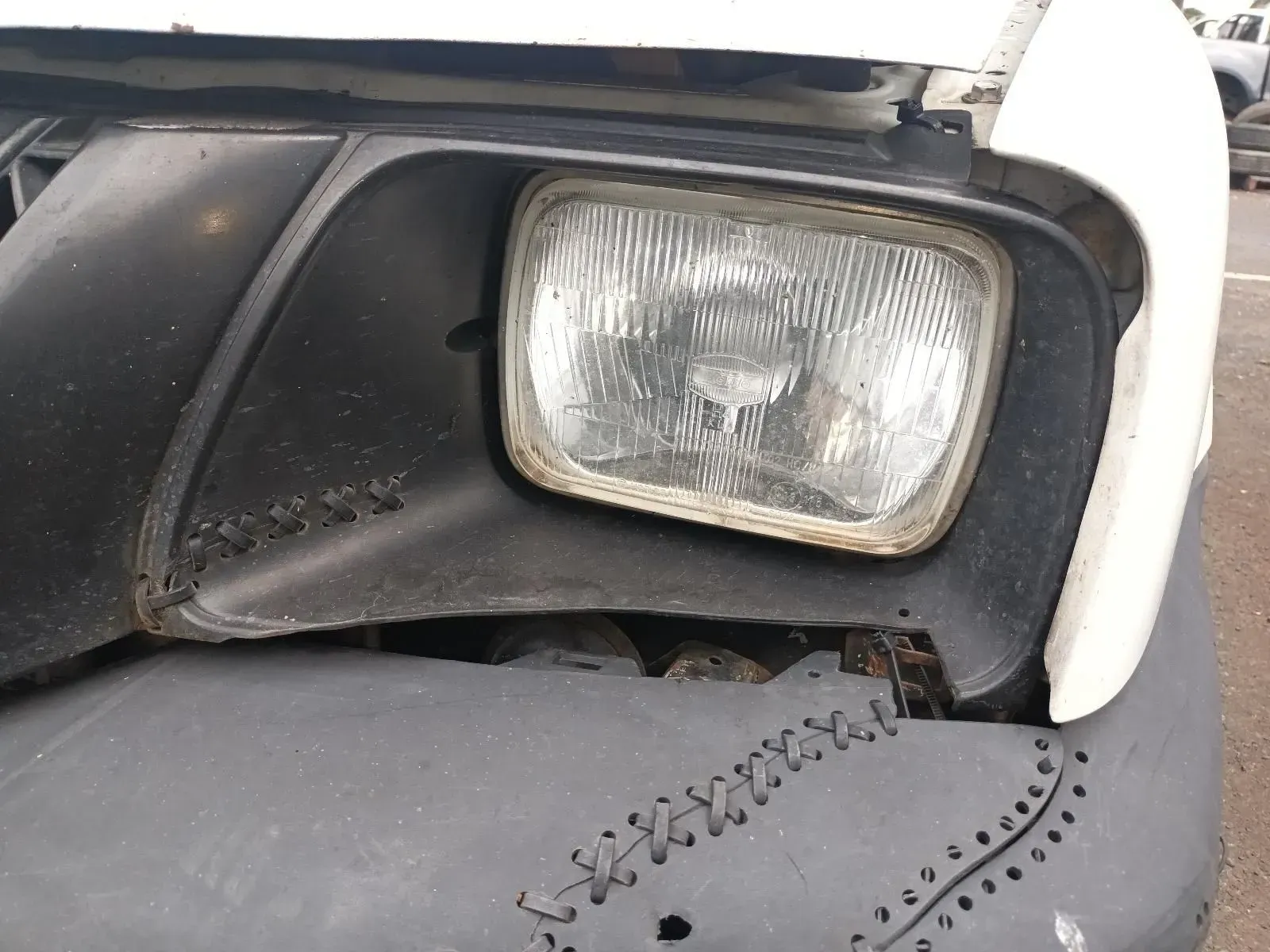 Close-up of a Damaged Car Headlight. Black and White — South West 4WD Wreckers In Brisbane, QLD