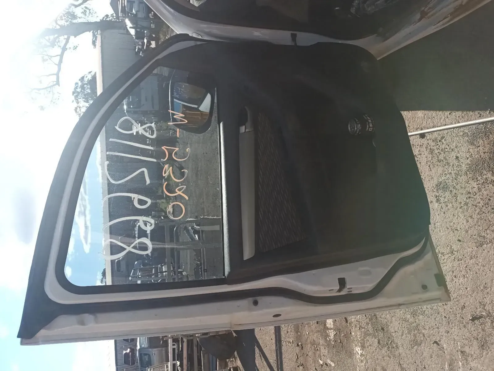 White Car Door, Open, With Glass and Black Interior Visible in a Salvage Yard — South West 4WD Wreckers In Brisbane, QLD