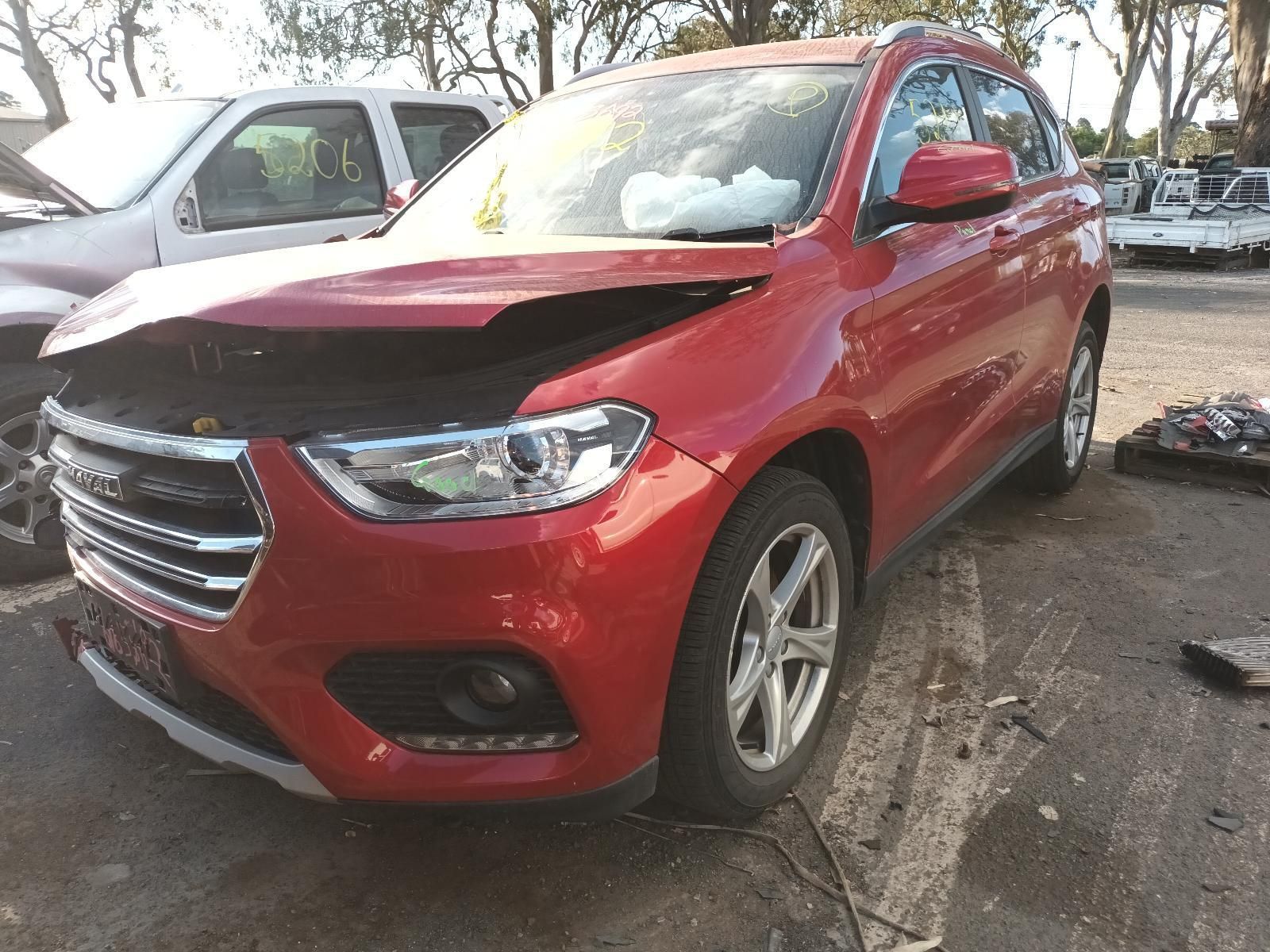 A Red Car with a Damaged Hood is Parked in a Parking Lot — South West 4WD Wreckers In Brisbane, QLD