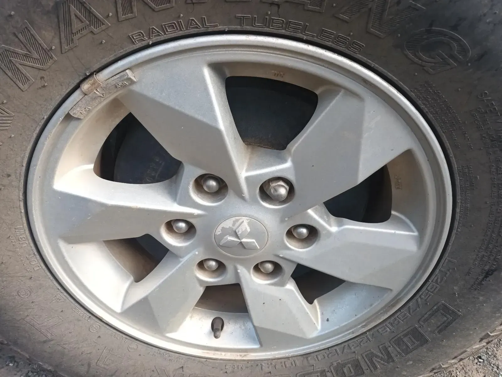 Silver Mitsubishi Car Wheel With a Black Tyre — South West 4WD Wreckers In Brisbane, QLD