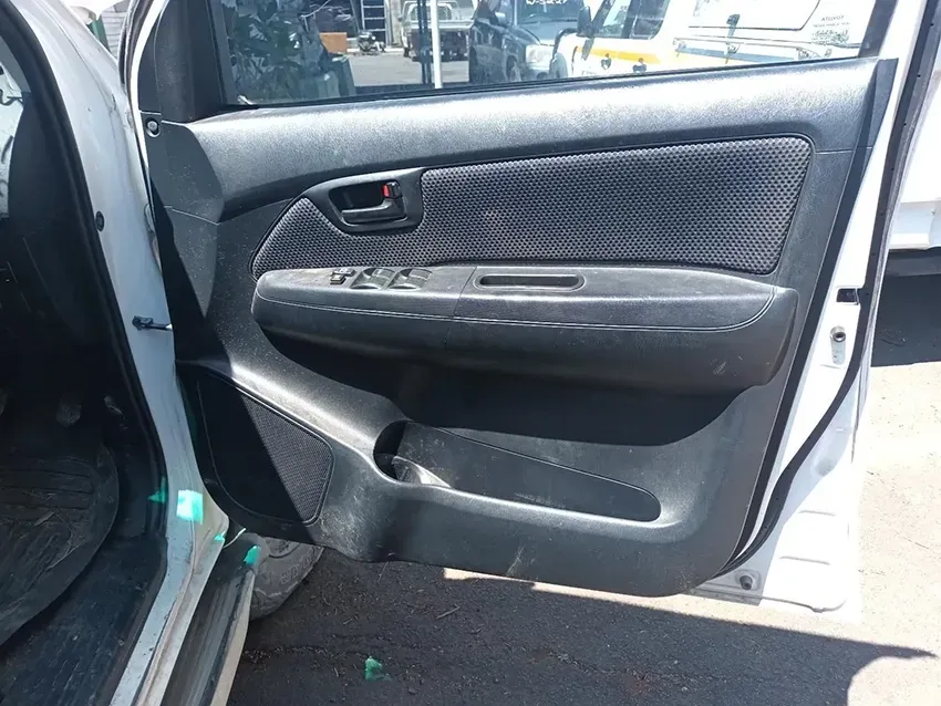 A White Car With the Door Open is Parked in a Parking Lot — South West 4WD Wreckers In Brisbane, QLD