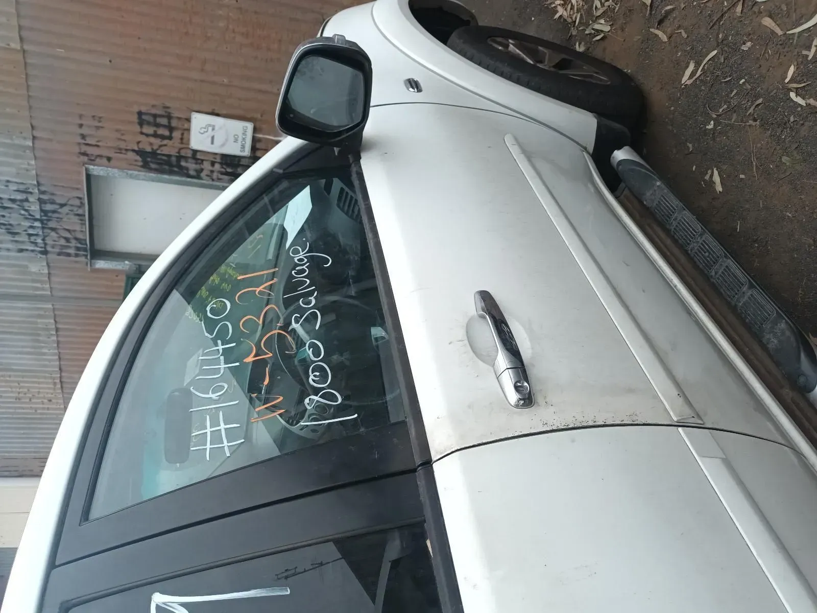 Side view of a silver car with a side mirror and door handle — South West 4WD Wreckers In Brisbane, QLD