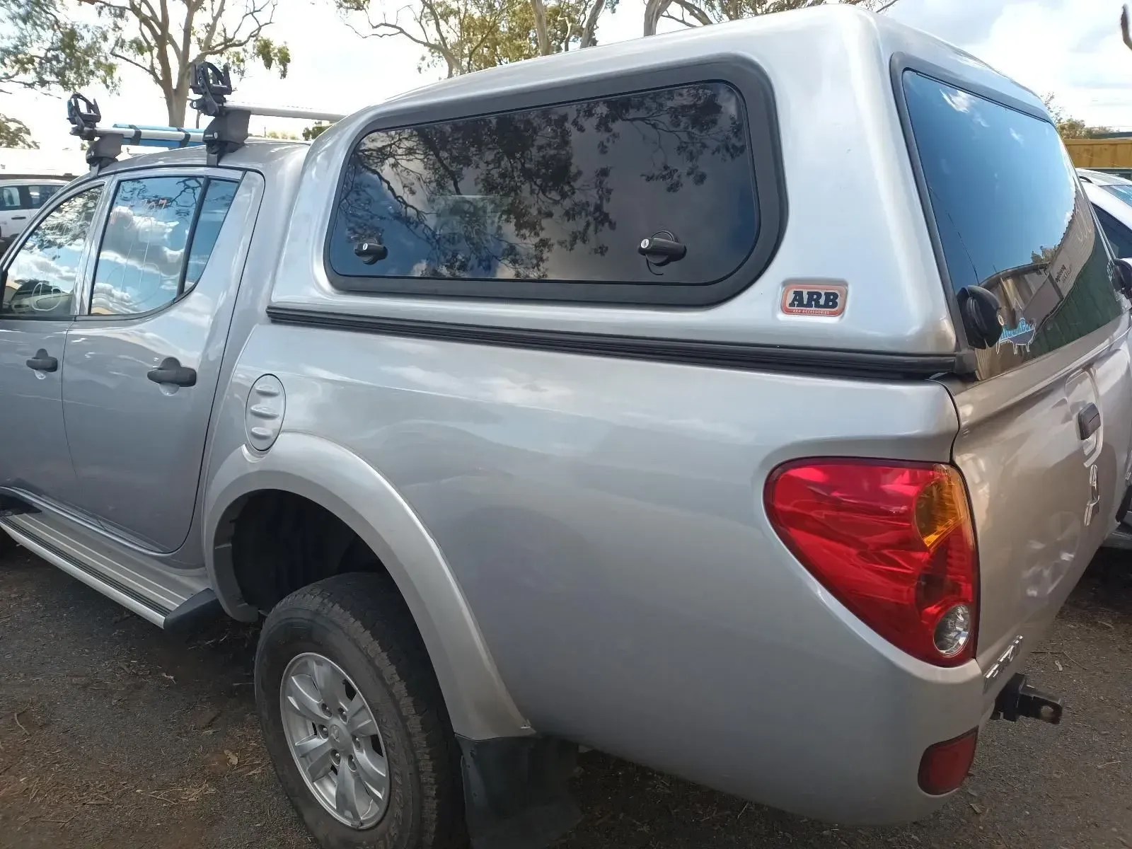 Silver Pickup Truck With a Canopy Parked Outdoors — South West 4WD Wreckers In Brisbane, QLD