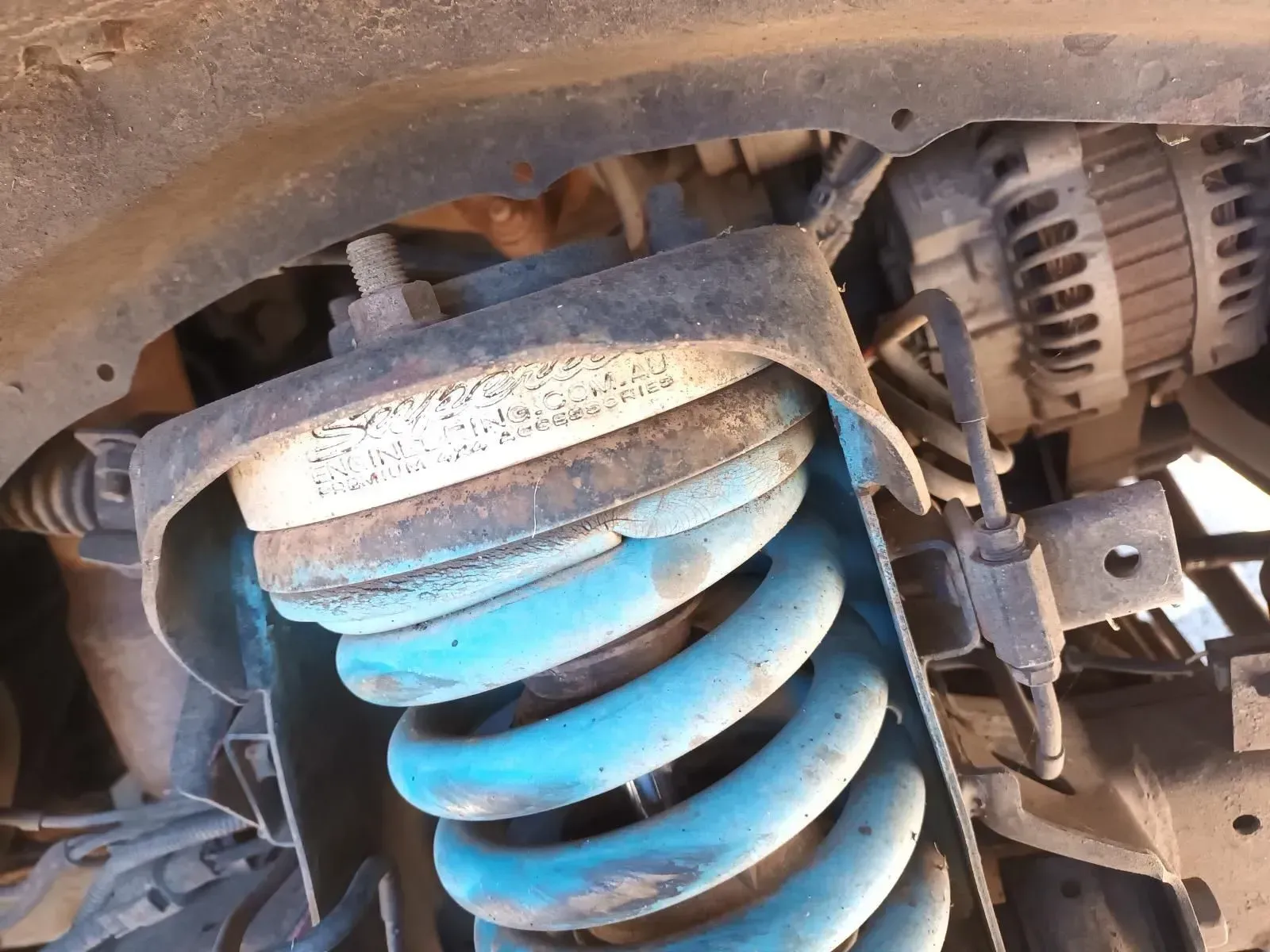 Blue Coil Spring and Shock Absorber in a Car's Suspension System — South West 4WD Wreckers In Brisbane, QLD