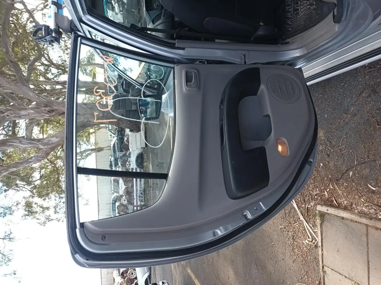 Gray Car Door Open, Showing the Interior Panel With Speaker and Handle — South West 4WD Wreckers In Brisbane, QLD