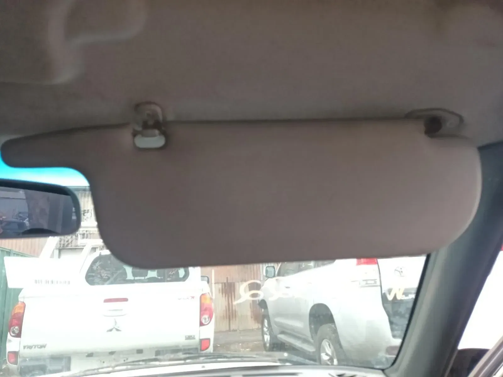 Beige Car Sun Visor Lowered, Blocking Sunlight — South West 4WD Wreckers In Brisbane, QLD