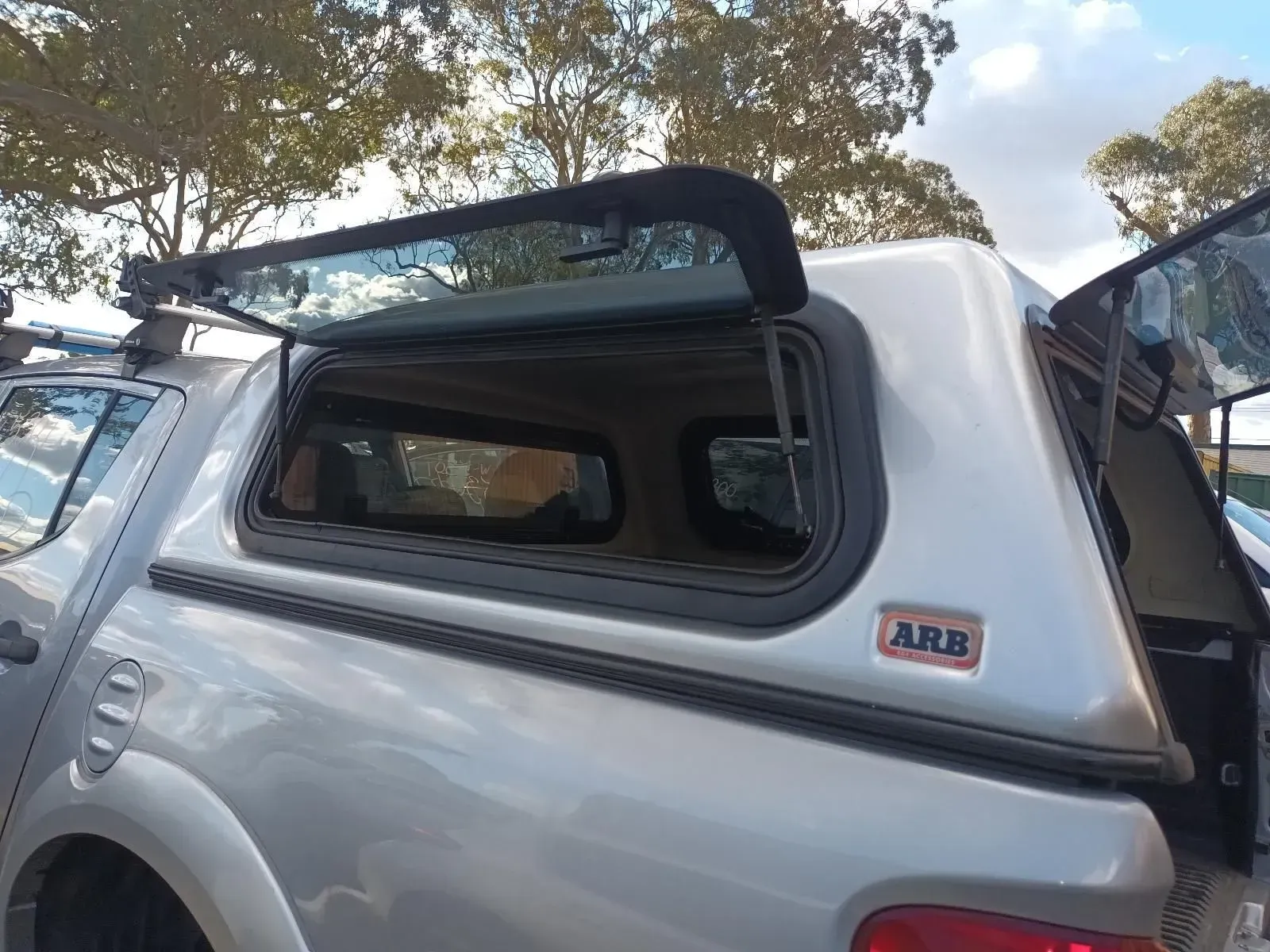 Silver Pickup Truck With a Silver Arb Canopy, Windows Open — South West 4WD Wreckers In Brisbane, QLD