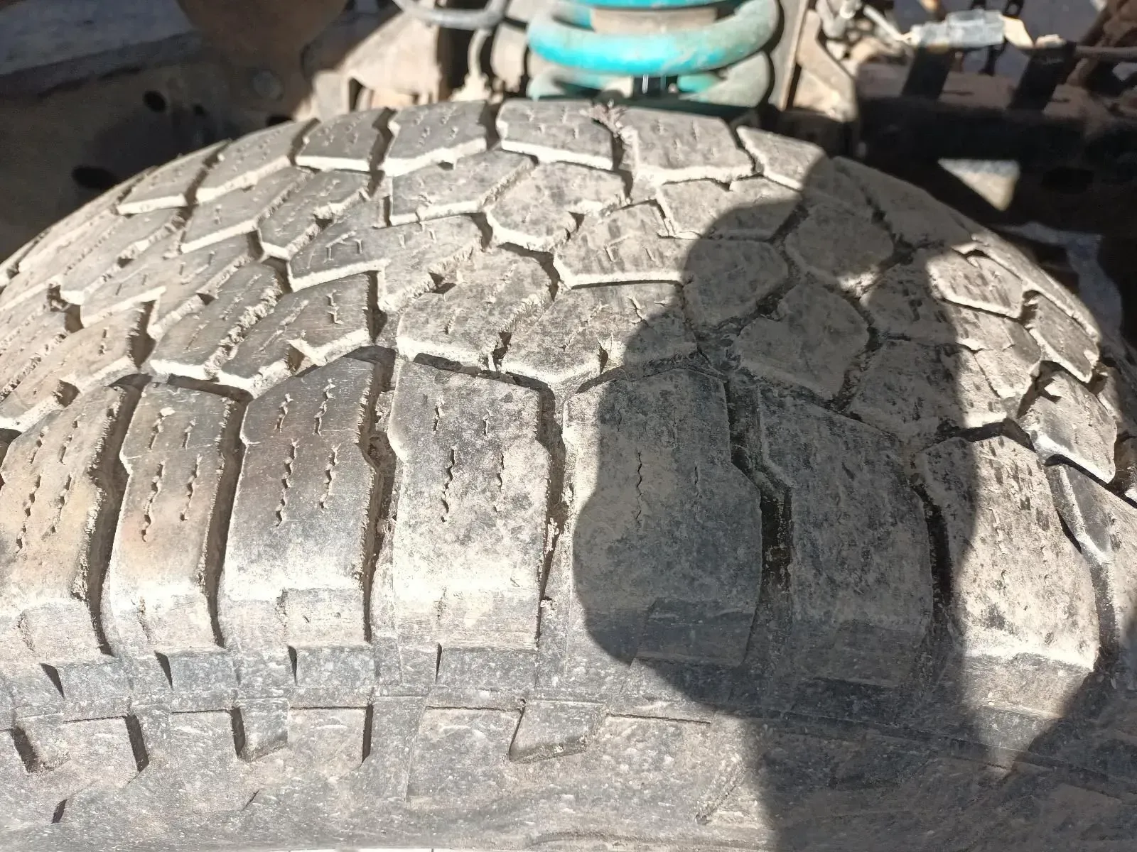 Close-up of a Worn, Muddy Tyre With a Distinct Tread Pattern on a Vehicle — South West 4WD Wreckers In Brisbane, QLD