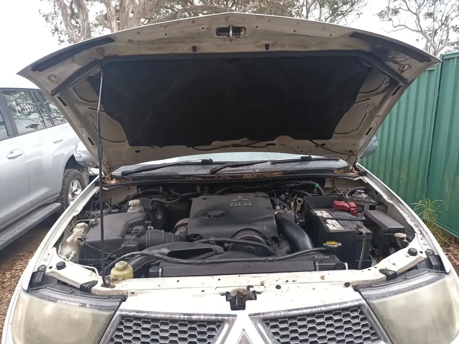 Open Hood of a Silver Pickup Truck Exposing the Engine in an Outdoor Setting — South West 4WD Wreckers In Brisbane, QLD
