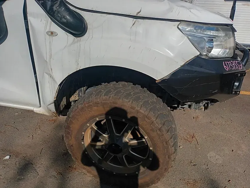 A White Truck with a Black Bumper is Parked on the Side of the Road — South West 4WD Wreckers In Brisbane, QLD