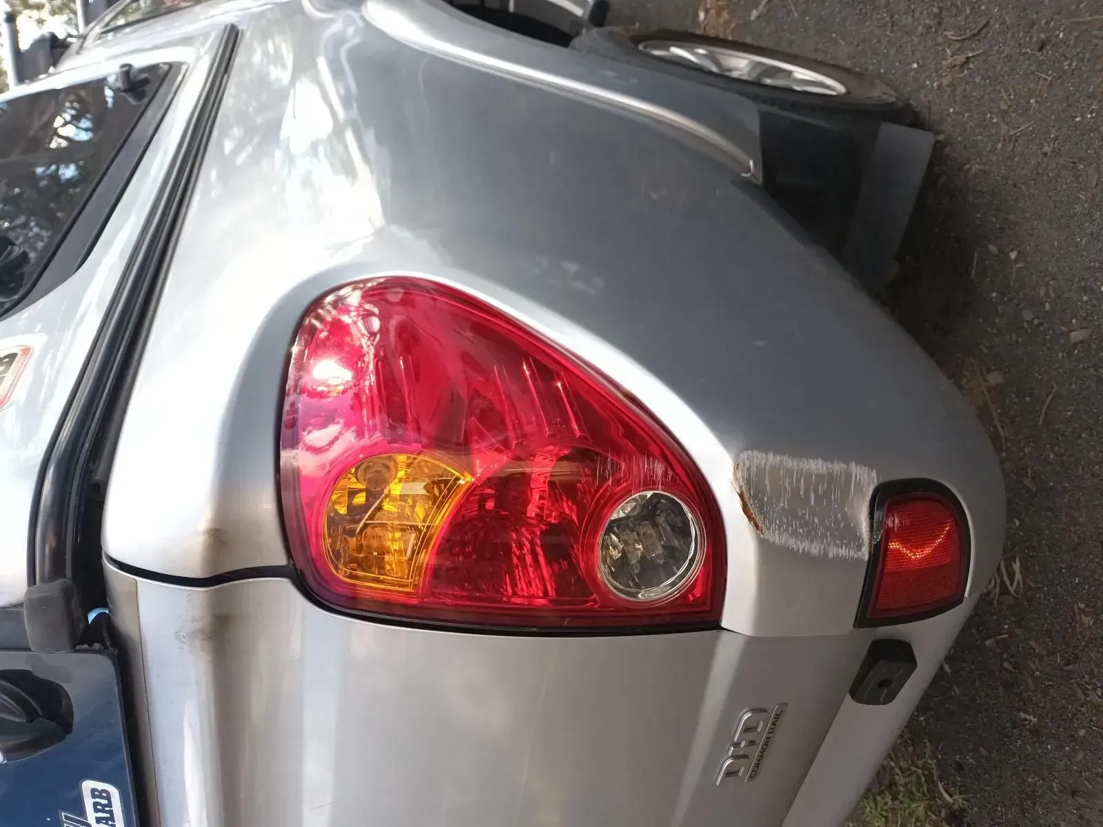Silver Car's Rear Quarter Panel With Taillight and Scraped Paint — South West 4WD Wreckers In Brisbane, QLD