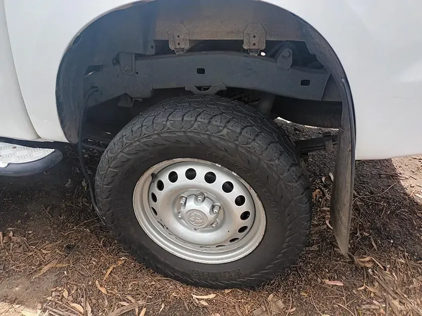 A White Truck with a Tire on the Ground — South West 4WD Wreckers In Brisbane, QLD 