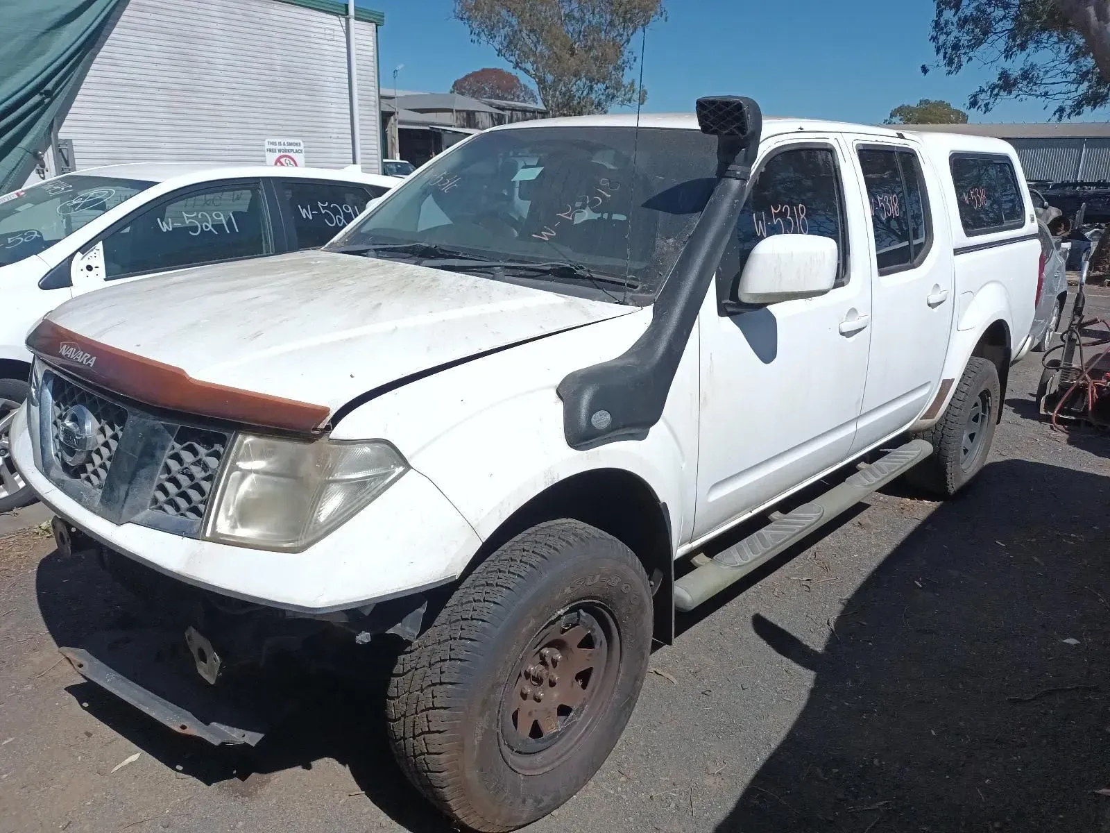 White Nissan Pickup Truck With a Snorkel, Parked in a Yard — South West 4WD Wreckers In Brisbane, QLD
