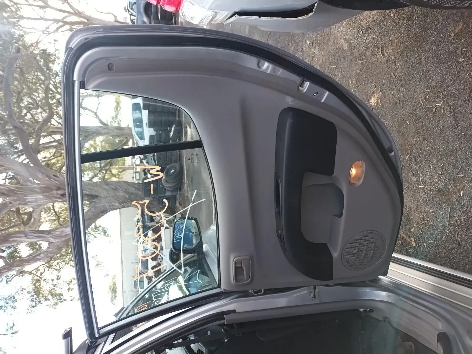 Car Door Open, Gray Interior, Window Down, Writing on Glass, Parked in Lot — South West 4WD Wreckers In Brisbane, QLD