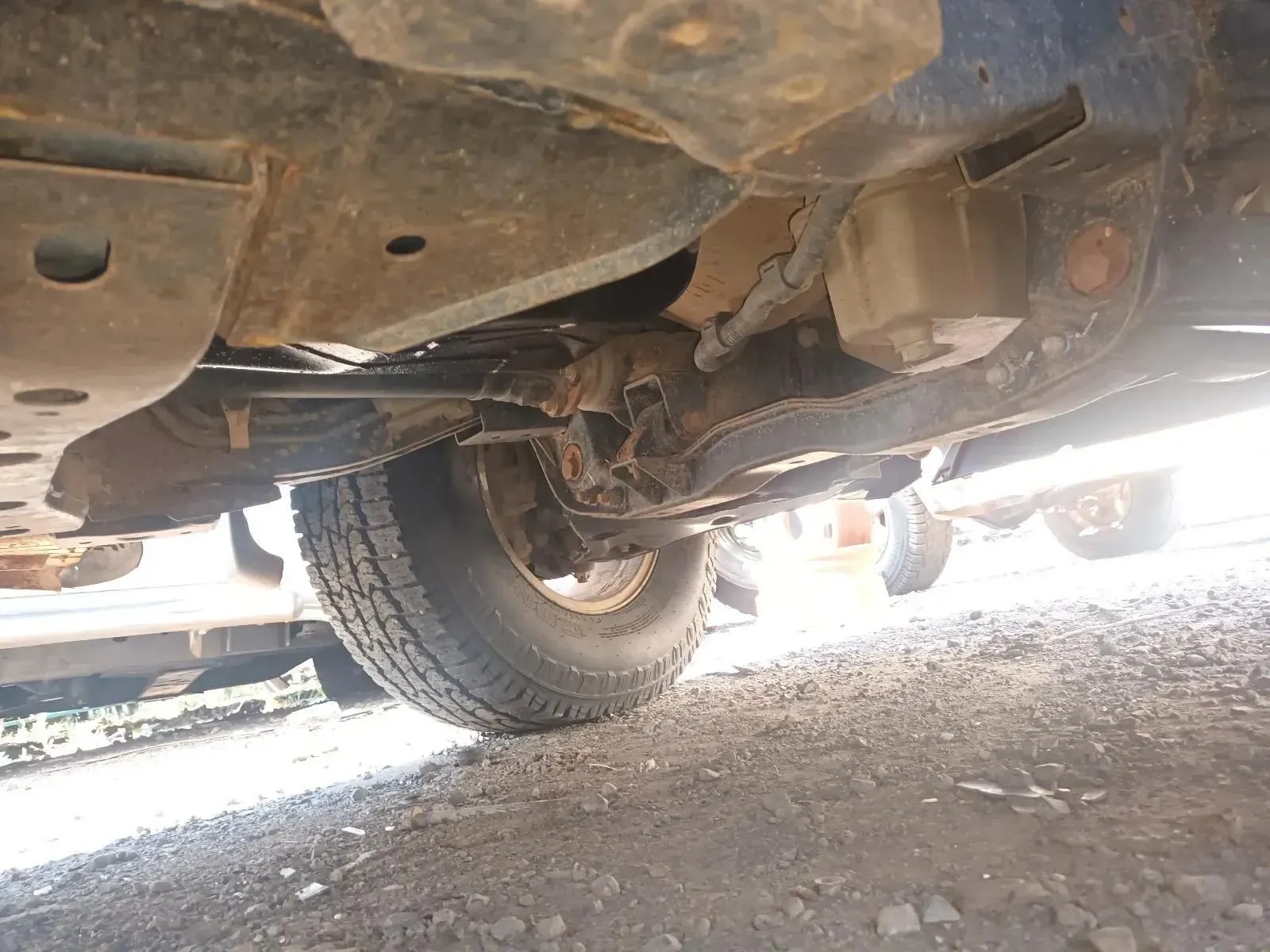 Undercarriage of a Vehicle, Showing a Tyre, Suspension Components, and Rusty Metal — South West 4WD Wreckers In Brisbane, QLD