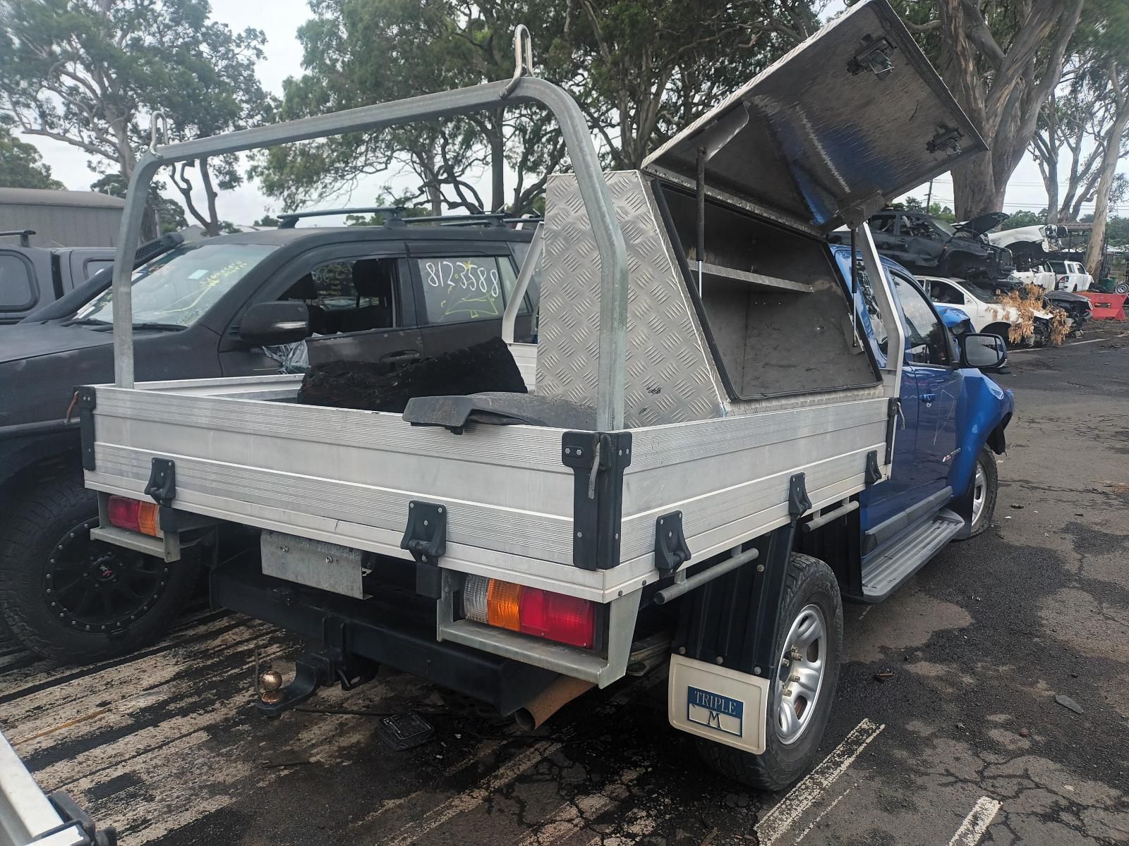 A Blue Truck with a Tray on the Back is Parked in a Parking Lot — South West 4WD Wreckers in Harristown, QLD