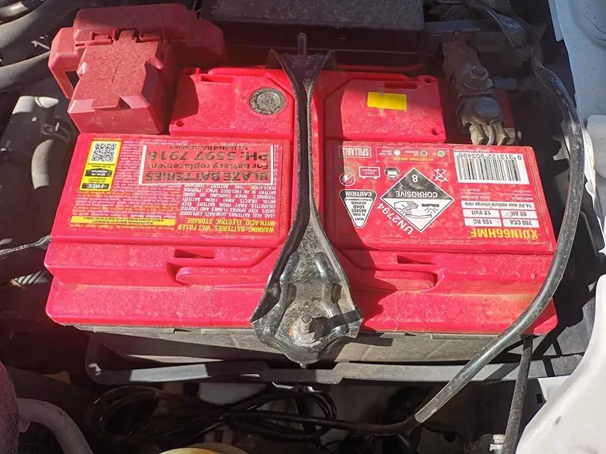 A Red Battery is Sitting Under the Hood of a Car — South West 4WD Wreckers In Brisbane, QLD