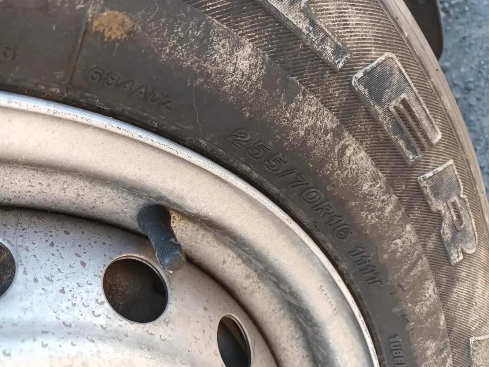 Close-up of a Tyre on a Silver Wheel With a Black Valve Stem — South West 4WD Wreckers In Brisbane, QLD