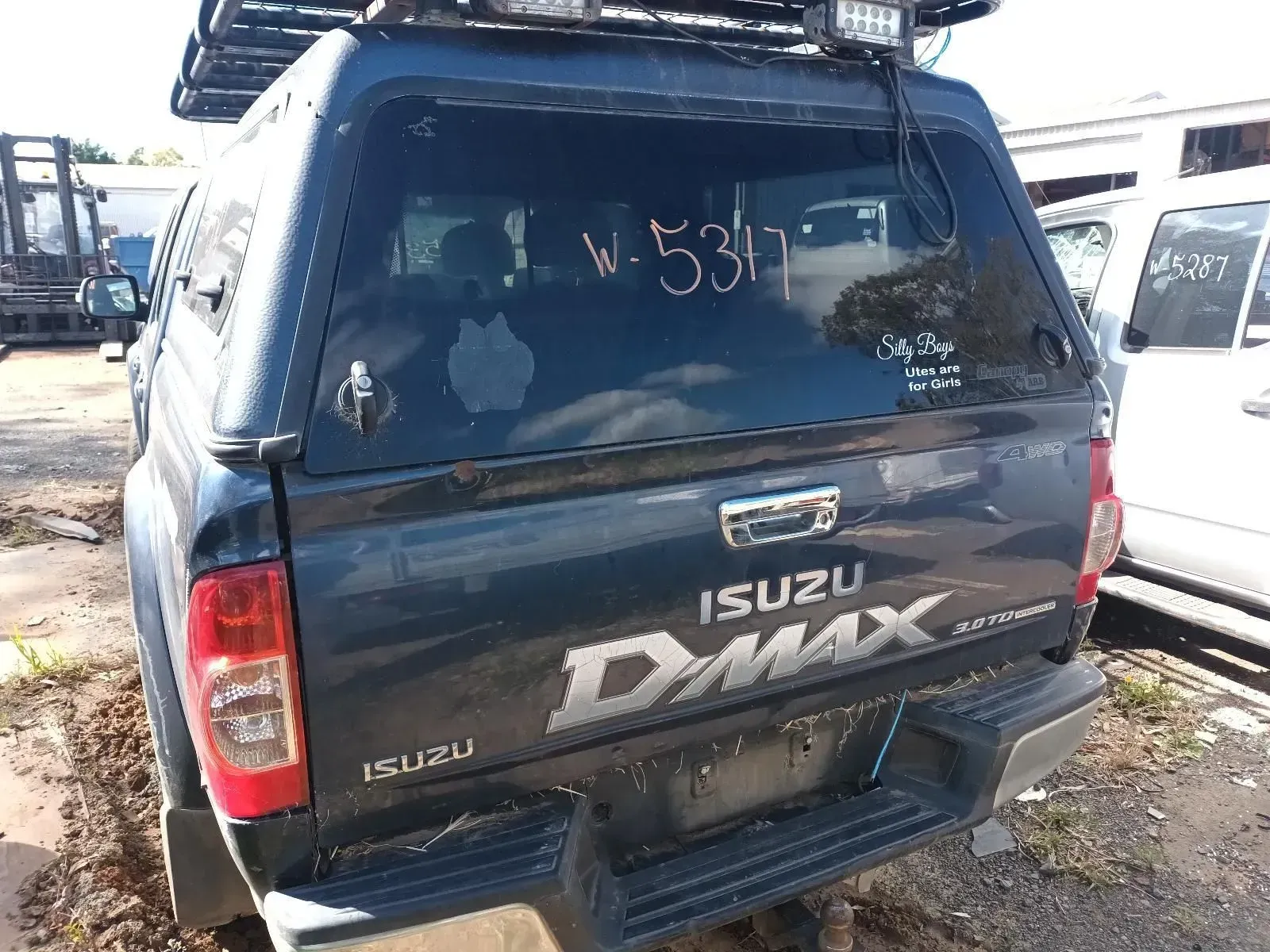 Dark Blue Isuzu D-max Pickup Truck With a Canopy and Roof Rack in a Junkyard — South West 4WD Wreckers In Brisbane, QLD