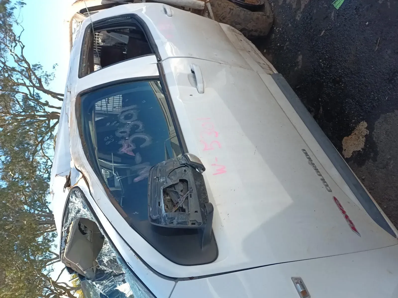 White Pickup Truck With Missing Side Mirror and Broken Windshield in a Junkyard — South West 4WD Wreckers In Brisbane, QLD
