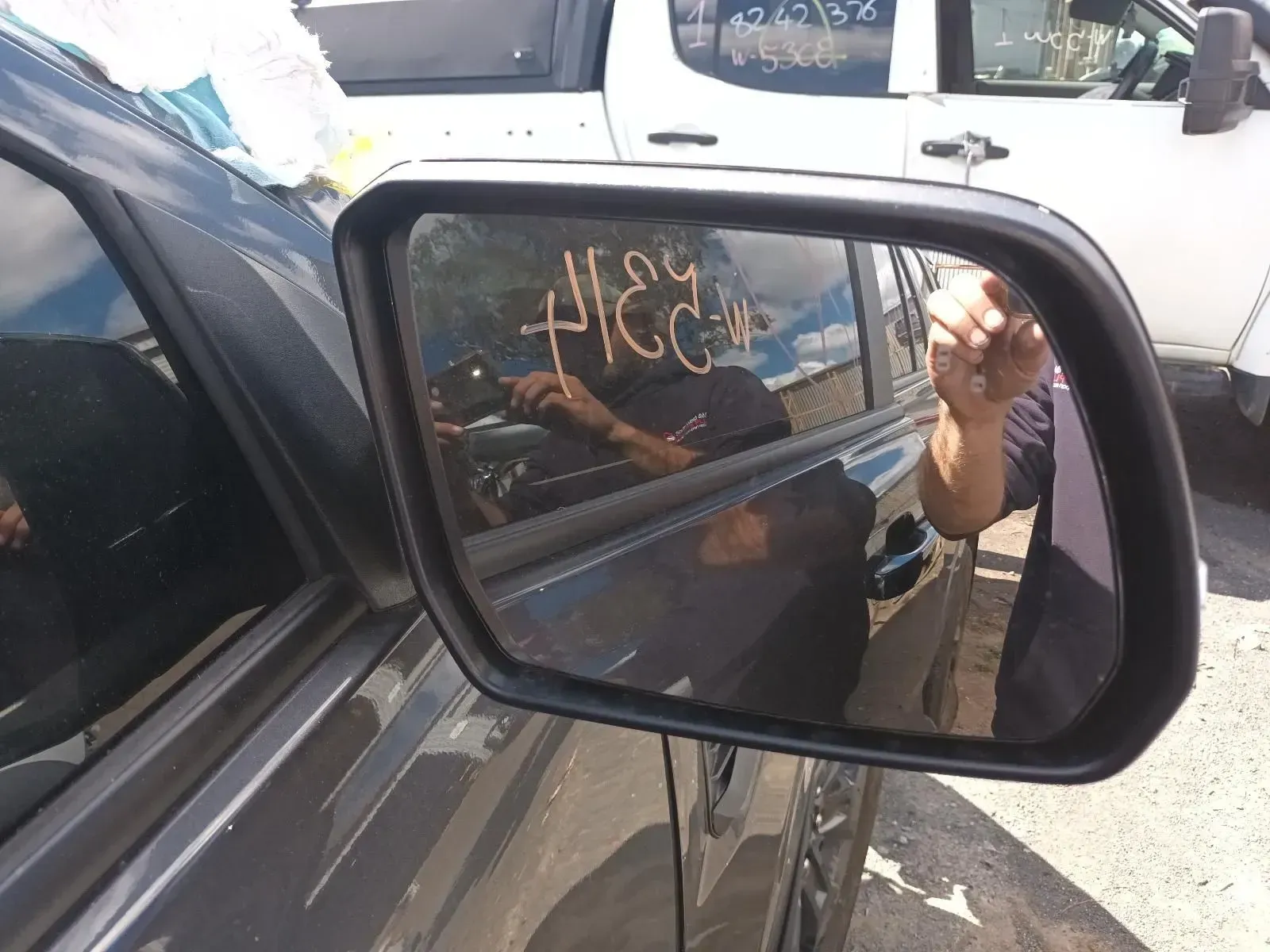 Car Side Mirror Reflecting a Person, Other Vehicles, and the Sky — South West 4WD Wreckers In Brisbane, QLD