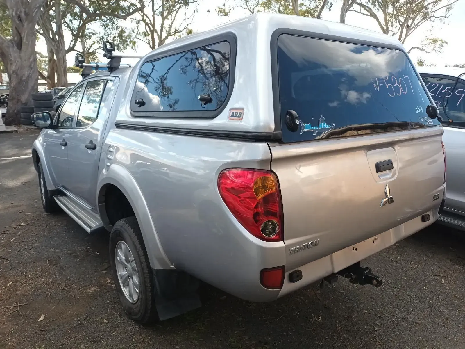 Silver Mitsubishi Triton Pickup Truck With a Canopy Parked Outdoors — South West 4WD Wreckers In Brisbane, QLD