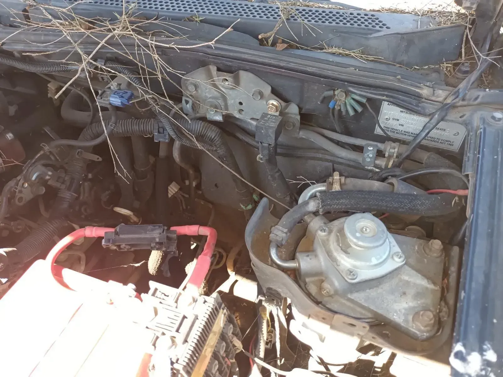 An Open Car Engine Bay With a Battery, Wiring — South West 4WD Wreckers In Brisbane, QLD