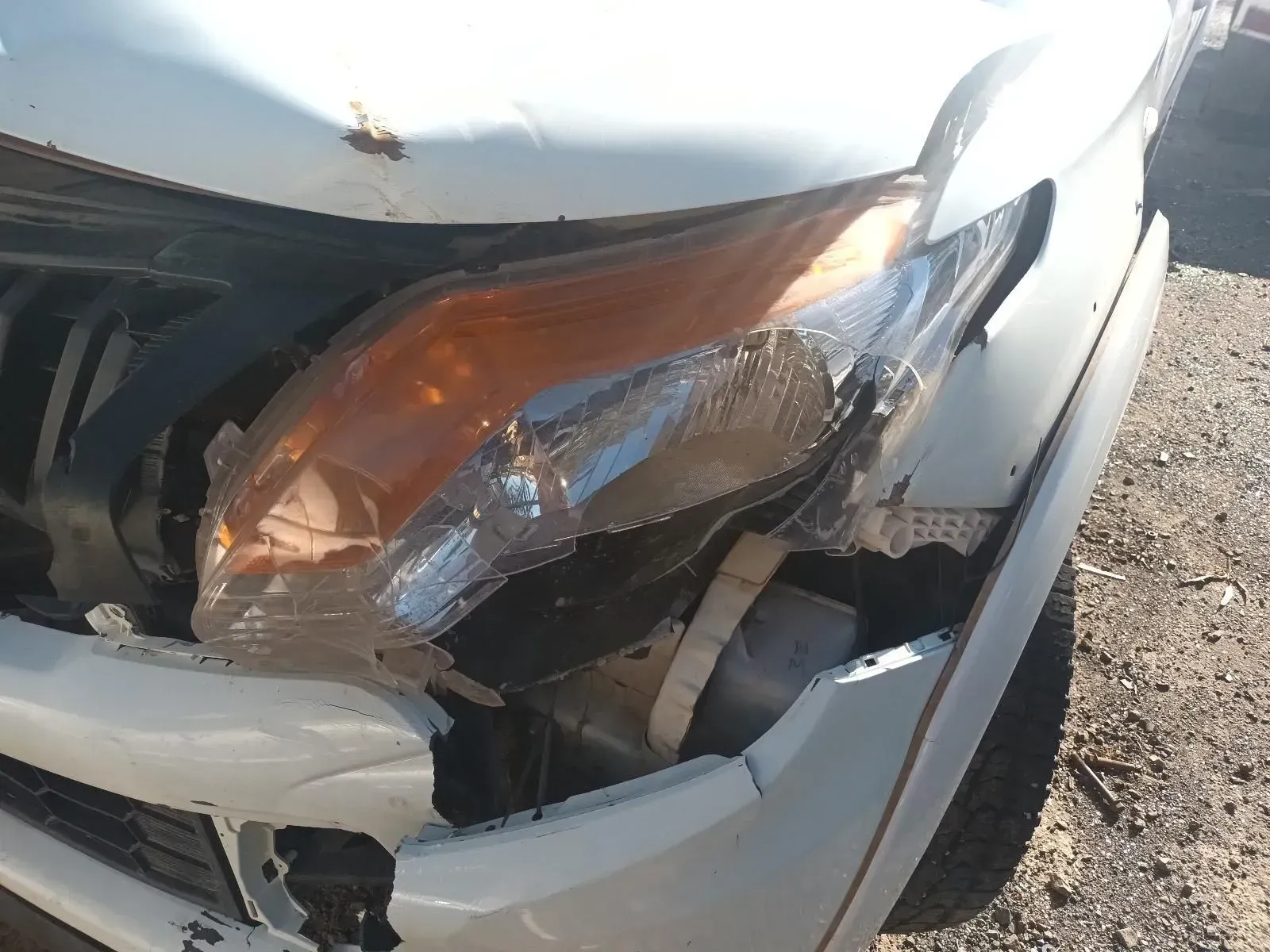 Damaged White Car Headlight and Front — South West 4WD Wreckers In Brisbane, QLD