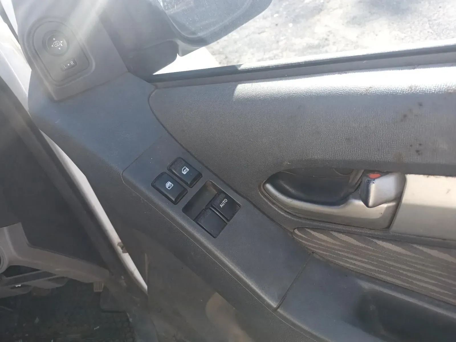 Close-up of a Black Car Door Panel With Window Controls and a Door Handle — South West 4WD Wreckers In Brisbane, QLD