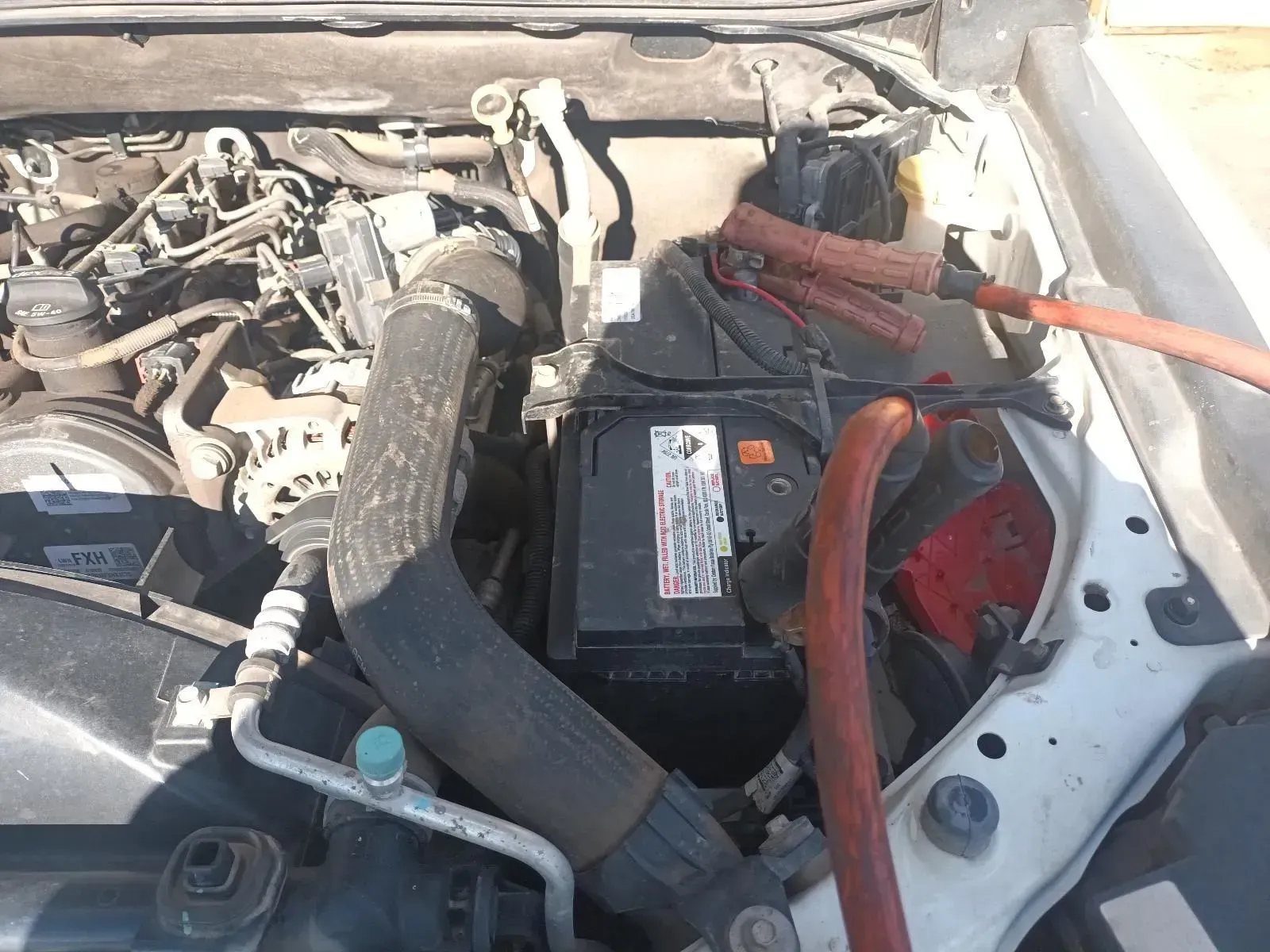 Car Engine Bay With Jumper Cables Connected to the Battery — South West 4WD Wreckers In Brisbane, QLD