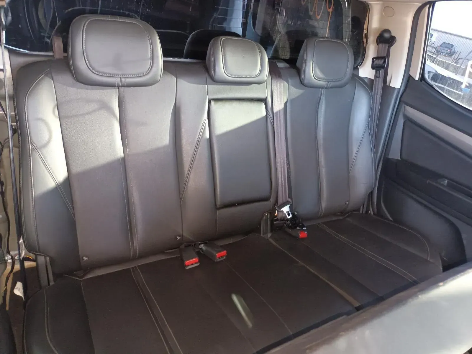 Black Leather Back Seats in a Vehicle, Three Headrests, Two Seatbelts Visible — South West 4WD Wreckers In Brisbane, QLD