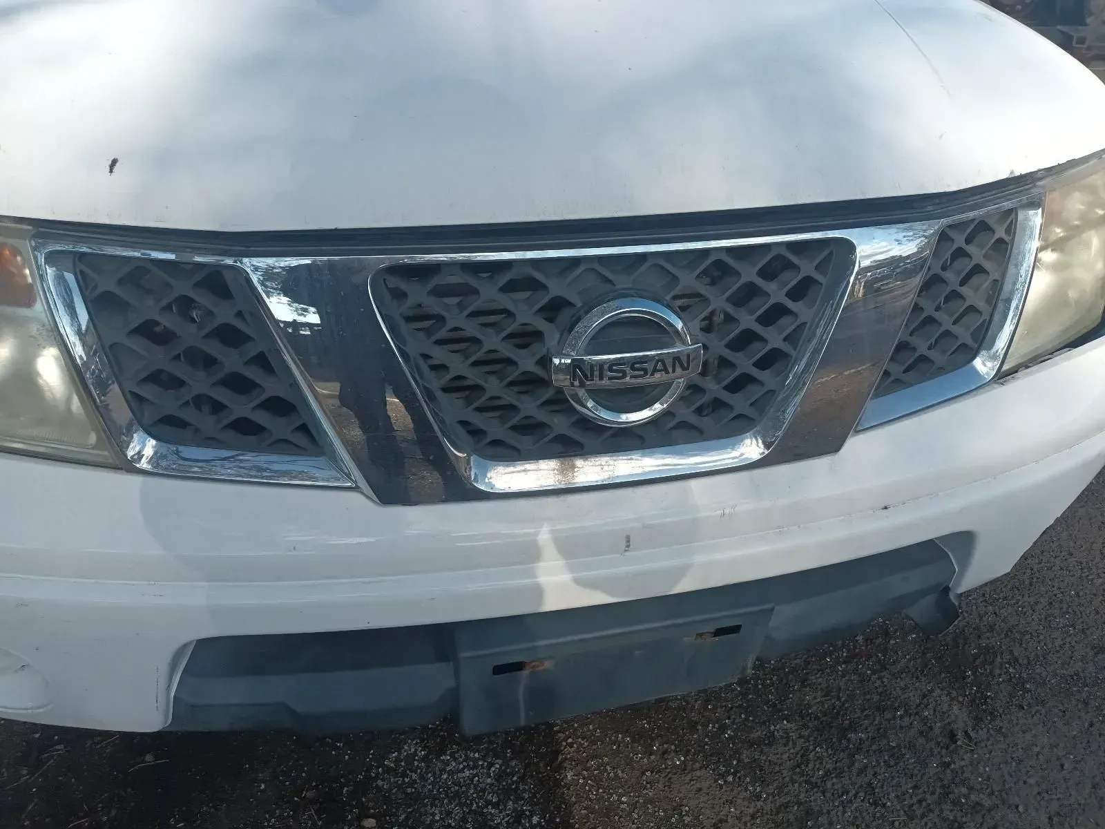 Close-up of a White Nissan Truck's Front Grille — South West 4WD Wreckers In Brisbane, QLD