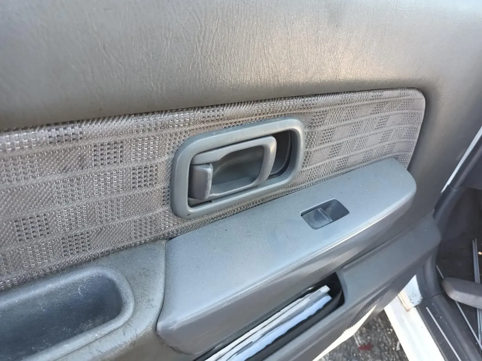 Gray Car Door Interior With a Door Handle, Window Control, and Patterned Fabric — South West 4WD Wreckers In Brisbane, QLD
