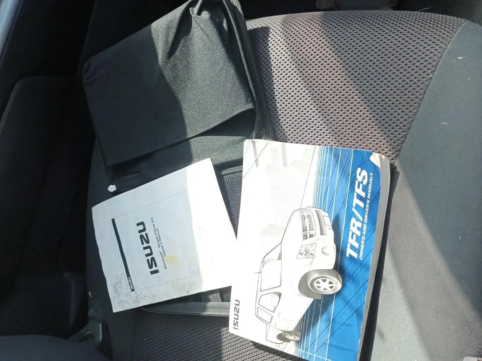 Two Vehicle Manuals and a Black Fabric Item on a Car Seat — South West 4WD Wreckers In Brisbane, QLD
