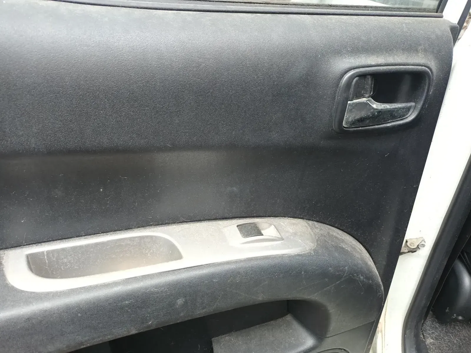 Black Car Door Interior With a Handle, Window Controls, and a White Door Frame — South West 4WD Wreckers In Brisbane, QLD