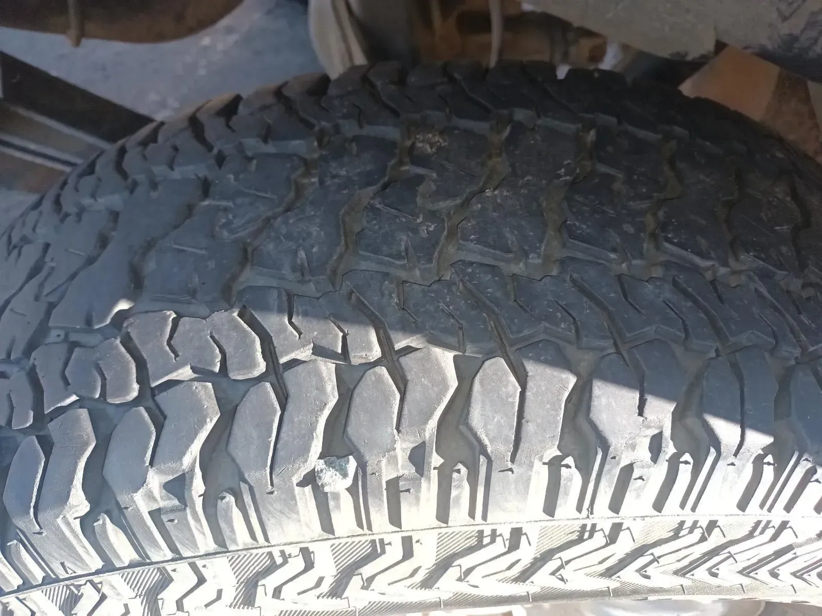 Close-up View of a Worn Black Tyre Tread With Visible Grooves and Some Dirt — South West 4WD Wreckers In Brisbane, QLD