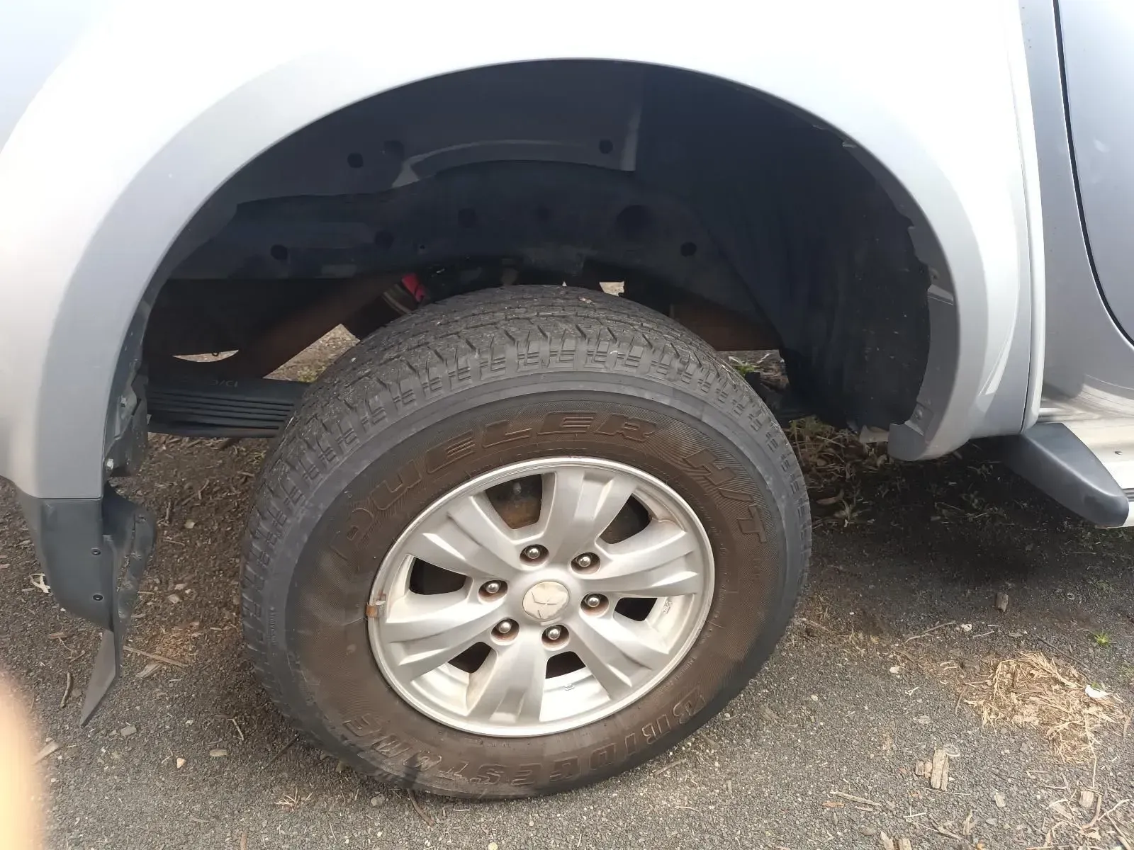 Silver Car Tyre and Wheel, Under the Wheel Well of a Silver Vehicle — South West 4WD Wreckers In Brisbane, QLD