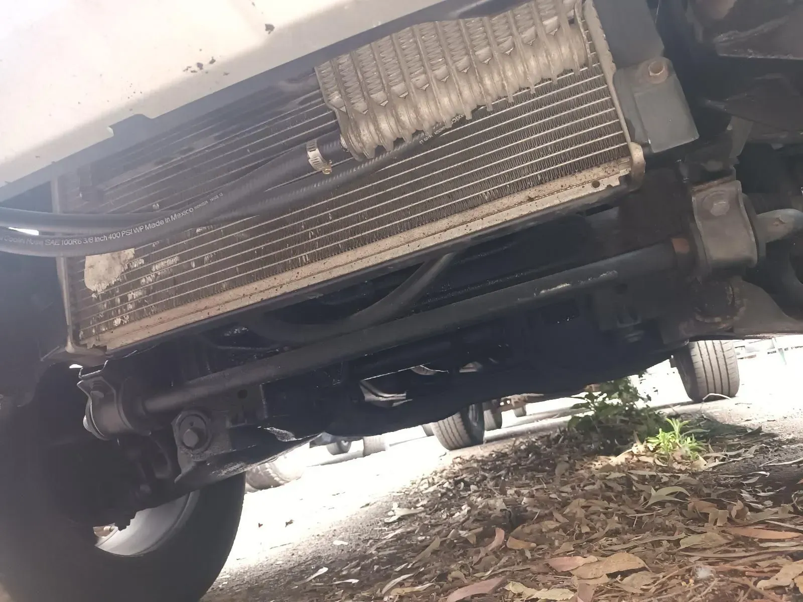 Underside of a Vehicle Showing a Dirty, Rectangular Radiator With Lines — South West 4WD Wreckers In Brisbane, QLD