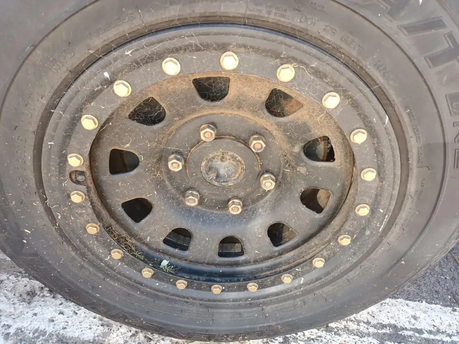 Black Car Wheel With Gold Accents, Covered in Dirt — South West 4WD Wreckers In Brisbane, QLD