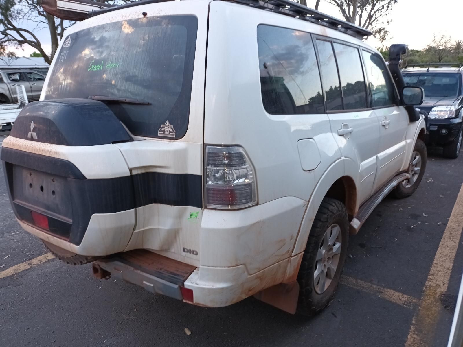 A White Mitsubishi Pajero is Parked in a Parking Lot — South West 4WD Wreckers in Harristown, QLD 