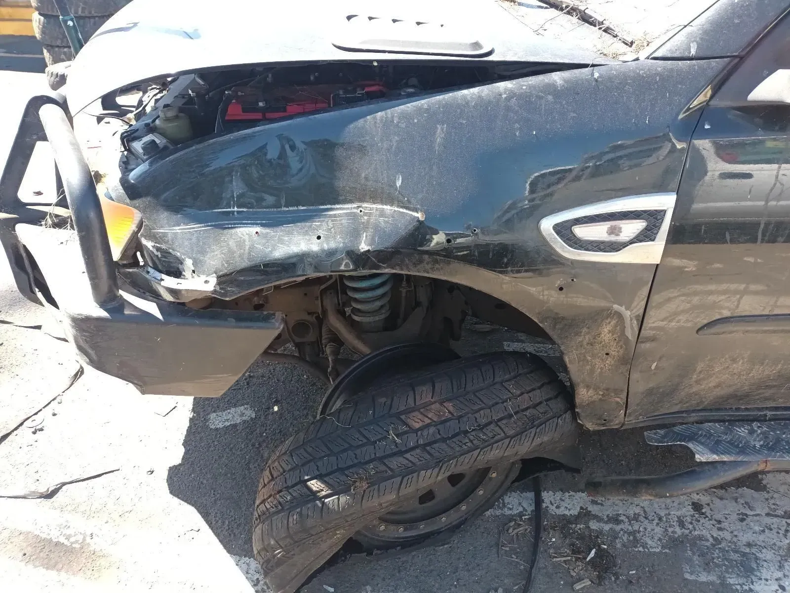 Damaged Black Suv With Crushed Front, Flat Tyre, and Visible Mechanical Components — South West 4WD Wreckers In Brisbane, QLD