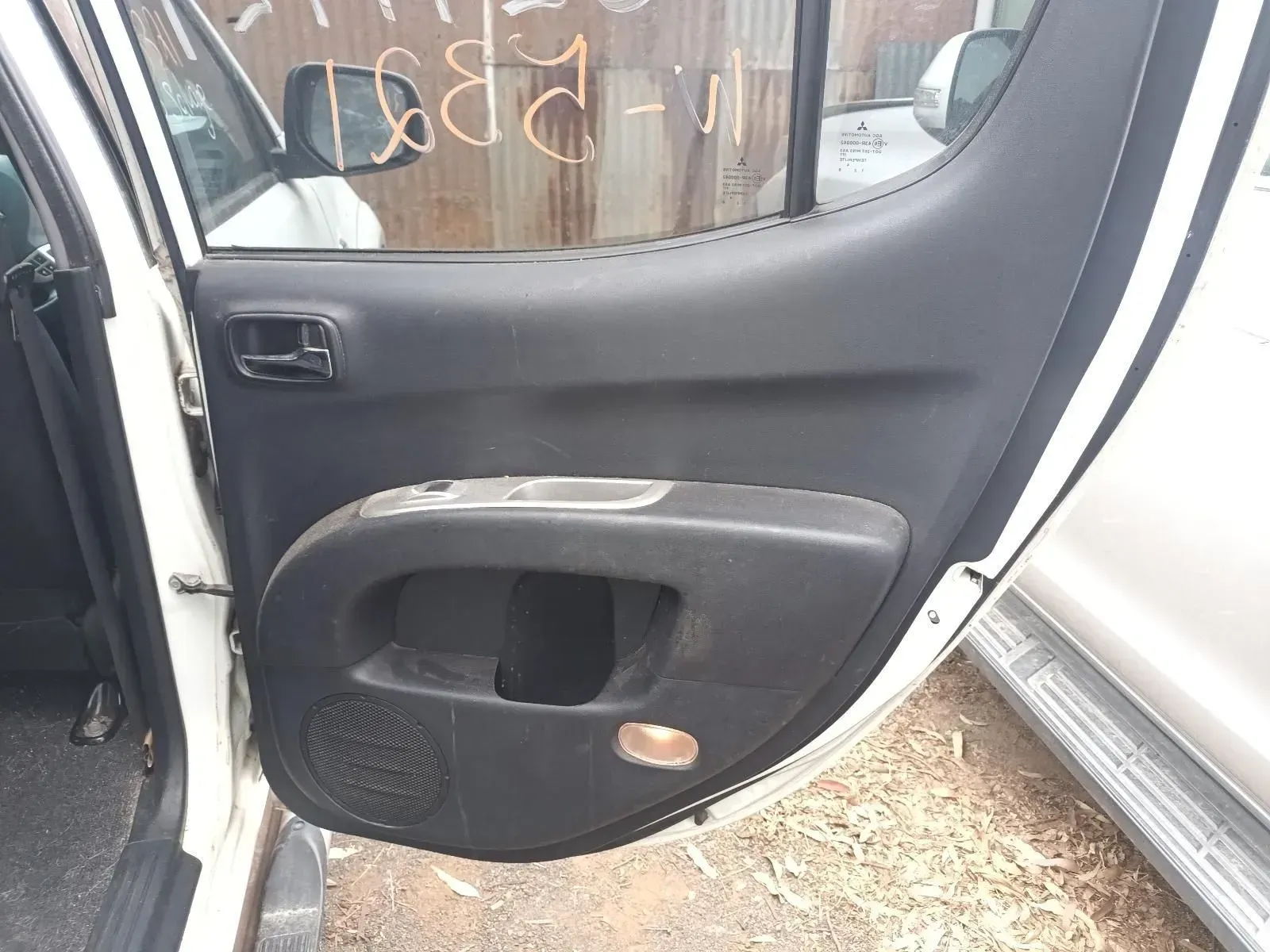 Black Interior Door Panel of a White Vehicle With a Handle, Speaker, and Light — South West 4WD Wreckers In Brisbane, QLD