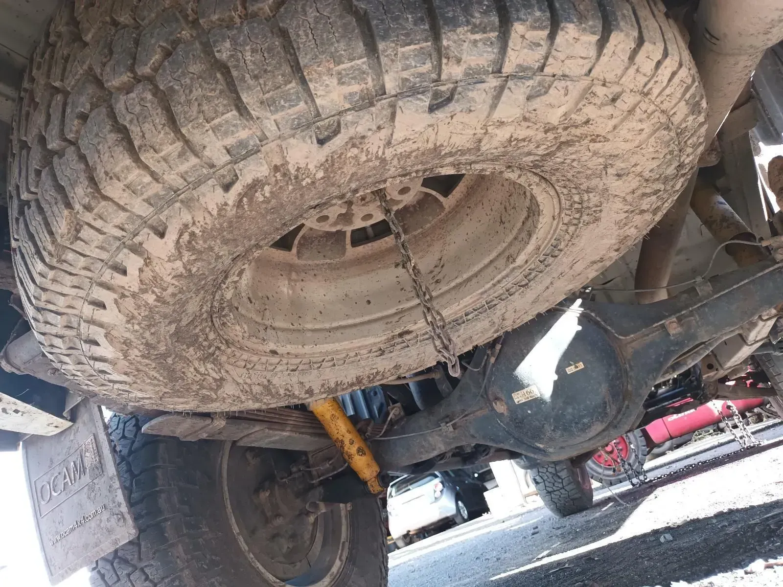 Underside of a Vehicle Showing a Spare Tyre Covered in Mud — South West 4WD Wreckers In Brisbane, QLD