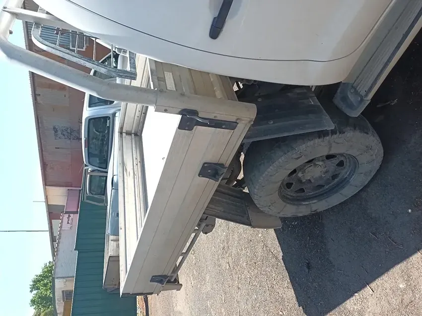 A White Truck With a Flat Bed is Parked in a Parking Lot — South West 4WD Wreckers In Brisbane, QLD