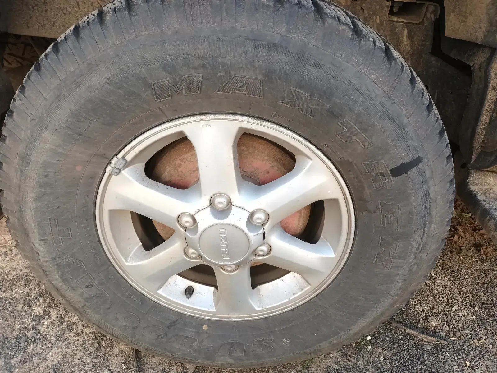 Close-up of a Dirty Vehicle Tyre With a Silver Rim, Showing Wear — South West 4WD Wreckers In Brisbane, QLD