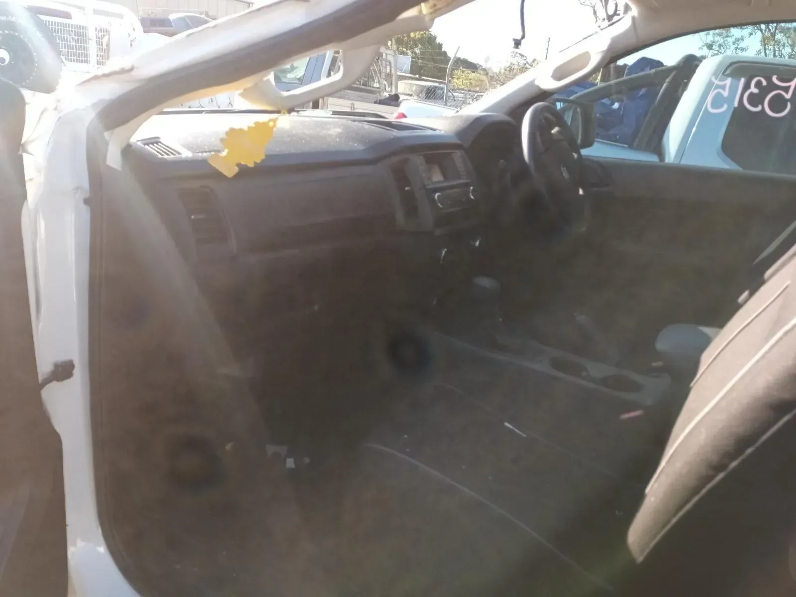 Interior of a White Truck With a Dark Dashboard, Steering Wheel, and Seats — South West 4WD Wreckers In Brisbane, QLD