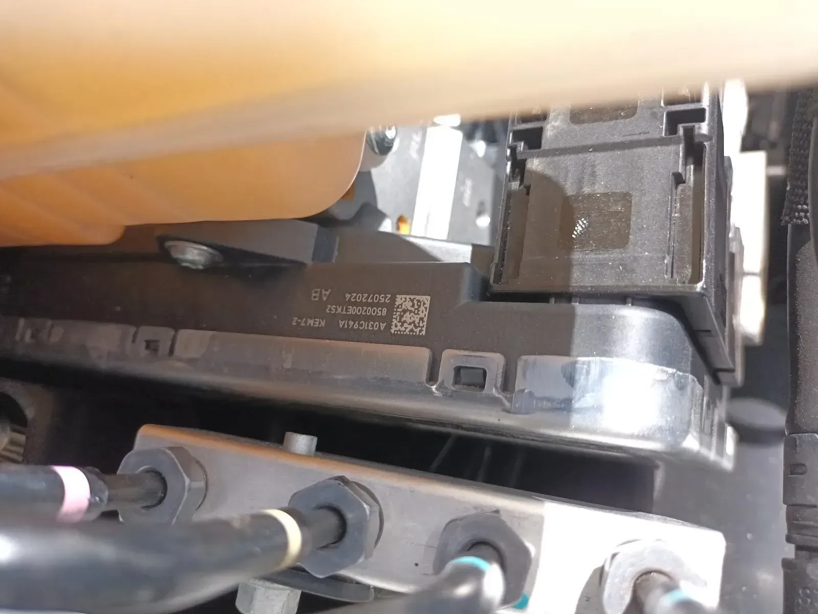 Close-up of a Car Component With Text and a Barcode, Near a Fluid Reservoir — South West 4WD Wreckers In Brisbane, QLD