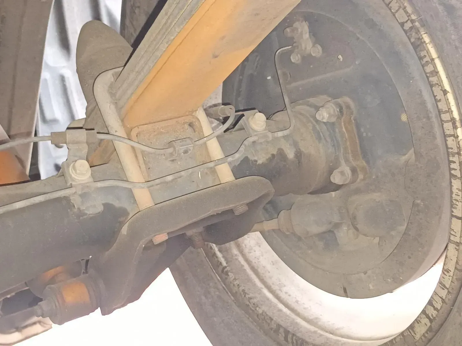Rear Suspension of a Vehicle With Leaf Springs and a Tyre Visible — South West 4WD Wreckers In Brisbane, QLD